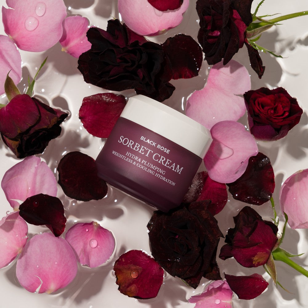 Hand applying Heimish Black Rose Sorbet Cream on face